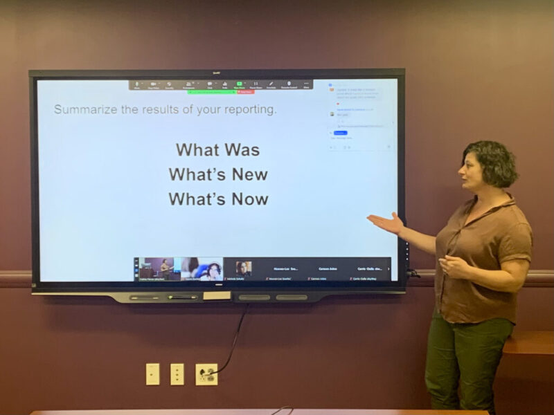 A photo of Dateline: CUNY editor Katina Paron giving a talk during the first Kiosk journalism workshop with a PowerPoint slide saying "What Was, What's New, What's Now."