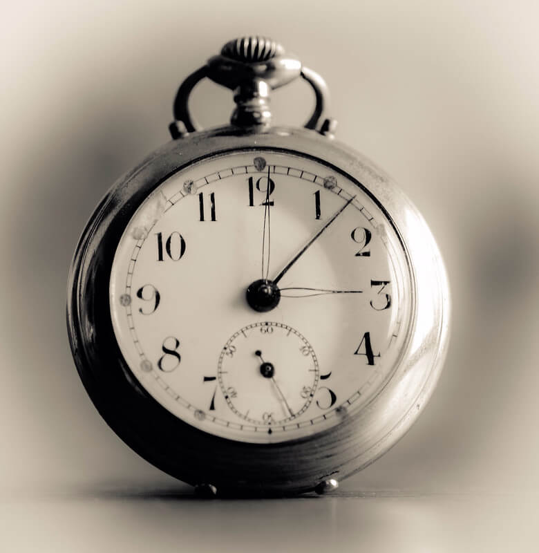 A black and white stock photo of a pocket watch.