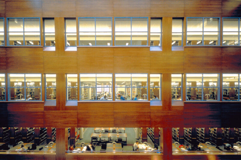A photo of the CUNY Baruch Newman Library building from the inside, with windows and desks.