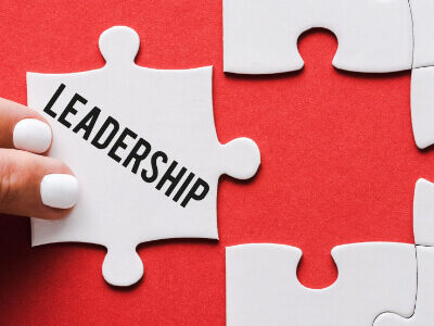 A stock image of a puzzle piece fitting in that says "Leadership."