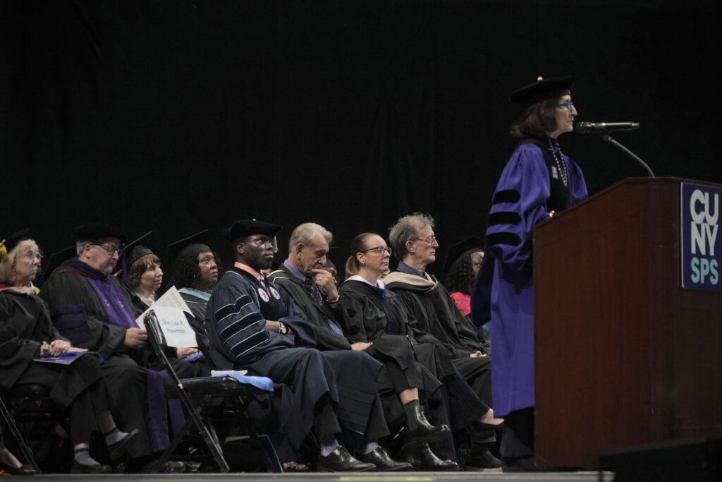 CUNY SPS staff and faculty look on as Dean Braverman speaks.